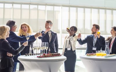 Colleagues on business event standing and toasting with champagne